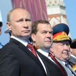 Vladimir Putin and Dmitry Medvedev attend a military parade in Moscow